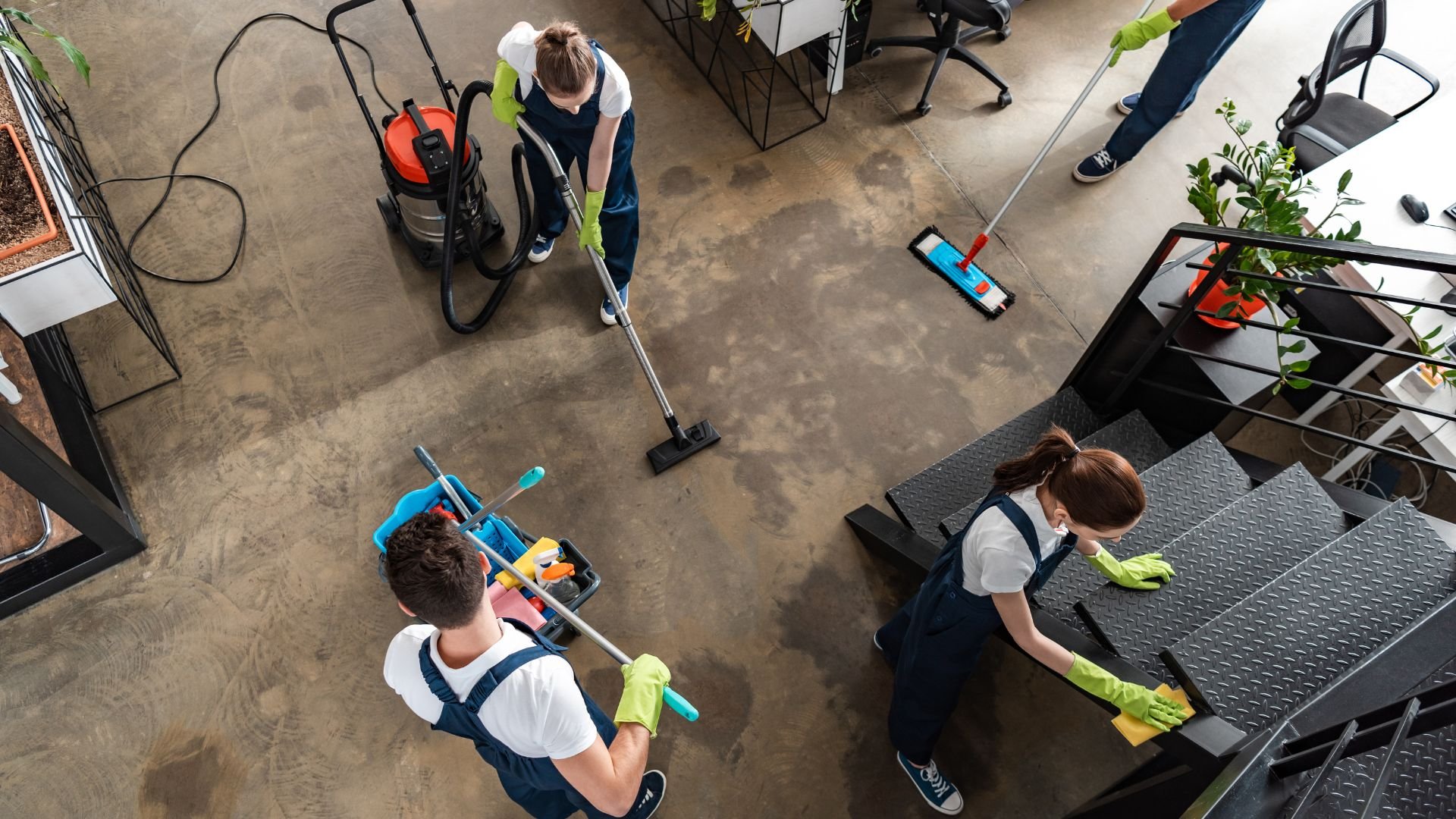 Cleaning staff using vacuum and mop to clean an industrial or office floor